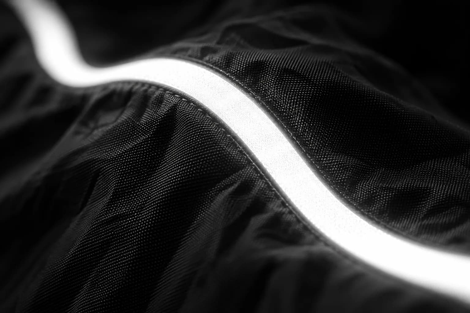 Reflective tape on ripstop nylon, lit by a flash